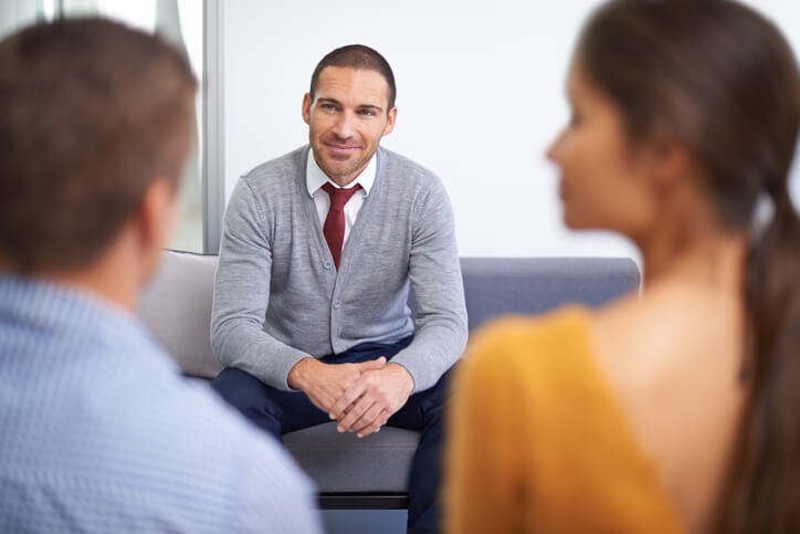 Couple meeting with man face-to-face at a local agency