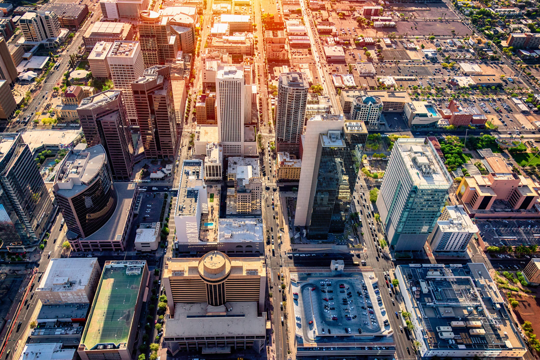 An aerial view of downtown Phoenix, Arizona and the surrounding urban area shot from a helicopter nearing dusk.