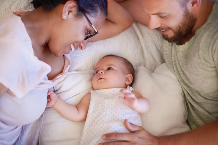Shot of a happy young man and woman bonding with their adorable babShot of a happy young man and woman bonding with their adorable baby girl at homey girl at home